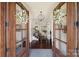 Inviting home entryway with dark wood floors, elegant chandelier, and a view into the living room and staircase at 141 Forsythia Ln, Tega Cay, SC 29708