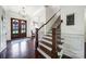 Inviting foyer showcasing hardwood floors, a staircase, and a double front door entrance at 141 Forsythia Ln, Tega Cay, SC 29708