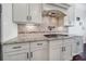 This gourmet kitchen features granite countertops, stainless steel appliances, and beautiful tile backsplash at 141 Forsythia Ln, Tega Cay, SC 29708