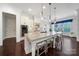 This eat-in kitchen features a large island with seating, stainless steel appliances and modern pendant lighting at 141 Forsythia Ln, Tega Cay, SC 29708