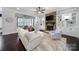 Relaxing living room features a stone fireplace, built-in shelves, and hardwood floors at 141 Forsythia Ln, Tega Cay, SC 29708