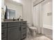 Modern bathroom with gray vanity, black fixtures, subway tiled shower and soaking tub at 1523 Saint George St, Charlotte, NC 28205
