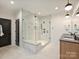 Modern bathroom featuring a glass enclosed shower with a bench and dual vanities at 1523 Saint George St, Charlotte, NC 28205