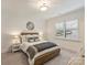Comfortable bedroom with neutral decor, wood frame bed and plantation shutters at 1523 Saint George St, Charlotte, NC 28205