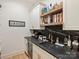 Butler's pantry features a countertop, a beverage cooler, and open wood shelving with decor at 1523 Saint George St, Charlotte, NC 28205