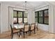 Bright dining room with a modern chandelier, white dining table and seating for six at 1523 Saint George St, Charlotte, NC 28205