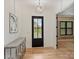 Light filled foyer with hardwood floors, black framed door, and modern console table at 1523 Saint George St, Charlotte, NC 28205