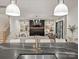 Kitchen island view to the living room featuring a fireplace, light hardwood floors, and custom finishes at 1523 Saint George St, Charlotte, NC 28205