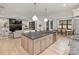 Open kitchen area view to the living and dining area featuring a fireplace and custom finishes at 1523 Saint George St, Charlotte, NC 28205