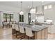 Modern kitchen boasts a large island with stone countertop, pendant lights, and stainless steel appliances at 1523 Saint George St, Charlotte, NC 28205