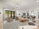 Open-concept living room features large windows, a stylish chandelier, and light hardwood floors at 1523 Saint George St, Charlotte, NC 28205