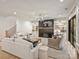 Cozy living room with a fireplace, custom shelving, and light hardwood floors at 1523 Saint George St, Charlotte, NC 28205