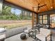 Covered patio featuring wood ceiling, stone flooring, and outdoor seating, perfect for entertaining at 1523 Saint George St, Charlotte, NC 28205