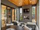 Covered patio with fireplace, wood ceiling, stone flooring, and outdoor seating at 1523 Saint George St, Charlotte, NC 28205