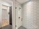 Modern shower with glass enclosure and chic hexagon tile, complemented by sleek hardware at 1523 Saint George St, Charlotte, NC 28205