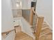Staircase features wood stairs with a modern black metal railing and a view to the entryway at 1523 Saint George St, Charlotte, NC 28205