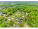 Aerial view of a residence featuring a neat lawn, set within a tranquil, tree-filled suburban area at 1545 Wimbleton Woods Dr, Fort Mill, SC 29708
