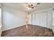 Bedroom with hardwood flooring, a ceiling fan, closet, and an ensuite bathroom at 1545 Wimbleton Woods Dr, Fort Mill, SC 29708