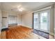 Inviting room with hardwood floors, ceiling fan, and French doors that lead to outdoor deck at 1545 Wimbleton Woods Dr, Fort Mill, SC 29708