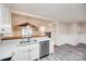 Well-lit kitchen with white cabinets, stainless steel appliances, and a view to the living room at 1545 Wimbleton Woods Dr, Fort Mill, SC 29708