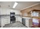 Modern kitchen featuring gray floors, stainless steel appliances, white cabinets, and subway tile backsplash at 1545 Wimbleton Woods Dr, Fort Mill, SC 29708