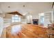 Living room featuring built-in shelving, fire place, fan, and hardwood floors at 1545 Wimbleton Woods Dr, Fort Mill, SC 29708