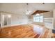 Living room with built-in shelving, fan, and hardwood floors at 1545 Wimbleton Woods Dr, Fort Mill, SC 29708