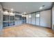 Spacious living room with hardwood floors, recessed lighting, and a custom built-in shelving unit at 1545 Wimbleton Woods Dr, Fort Mill, SC 29708