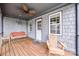 Charming front porch features gray siding, a swing, and an Adirondack chair at 1545 Wimbleton Woods Dr, Fort Mill, SC 29708