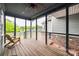 Relaxing screened-in porch with a wooden deck, and a wooden chair at 1545 Wimbleton Woods Dr, Fort Mill, SC 29708