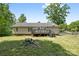 Exterior view of the home showcasing a spacious backyard with a deck and lush lawn at 1756 Martin Rd, Kings Mountain, NC 28086