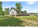 Back of house featuring vinyl siding, windows, and a wood deck overlooking the yard at 1756 Martin Rd, Kings Mountain, NC 28086