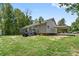 The back of the house showing the deck, carport, and vinyl siding in the yard at 1756 Martin Rd, Kings Mountain, NC 28086