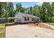 Inviting ranch with carport features manicured landscaping, beautiful flowerbed, and an expansive concrete driveway at 1756 Martin Rd, Kings Mountain, NC 28086