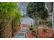 Lush backyard featuring a stone pathway, manicured landscaping, and a charming cottage-style building at 1801 Wilmore Dr, Charlotte, NC 28203