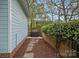 Private backyard with a grill, wooden fence, and stone pathway, perfect for outdoor entertaining and relaxation at 1801 Wilmore Dr, Charlotte, NC 28203