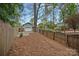 Backyard features a detached garage and a partially-wooded lot surrounded by a wooden fence at 1801 Wilmore Dr, Charlotte, NC 28203