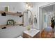 Charming bathroom with decorative gold mirror, floating shelves, and wood vanity at 1801 Wilmore Dr, Charlotte, NC 28203