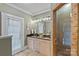 Bathroom featuring double sinks, stone tile flooring, and a glass-enclosed shower at 1801 Wilmore Dr, Charlotte, NC 28203