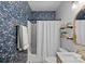 Bathroom with floral wallpaper, shower and bath, vanity, and stylish fixtures at 1801 Wilmore Dr, Charlotte, NC 28203