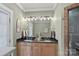 Bathroom with double vanity, black countertops and modern lighting fixtures at 1801 Wilmore Dr, Charlotte, NC 28203