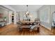 Bright dining room with a wooden table set, chandelier, and window views at 1801 Wilmore Dr, Charlotte, NC 28203