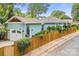Charming light blue home features a garage and privacy fence, complemented by lush landscaping at 1801 Wilmore Dr, Charlotte, NC 28203