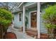 Charming front entrance with a wooden door, brick steps, and lush greenery, creating a welcoming first impression at 1801 Wilmore Dr, Charlotte, NC 28203