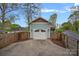 A detached one car garage features white doors, craftsman details, and ample driveway space at 1801 Wilmore Dr, Charlotte, NC 28203