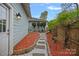 Scenic view of the landscaped side yard featuring a stone pathway, manicured shrubbery, and blooming flowers at 1801 Wilmore Dr, Charlotte, NC 28203