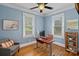 Bright home office features hardwood floors, a modern desk setup, and natural light from the windows at 1801 Wilmore Dr, Charlotte, NC 28203