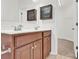 Bathroom featuring double sinks, vanity with storage, and decorative shelving at 1828 Aston Mill Pl, Charlotte, NC 28273