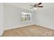 Bedroom with a ceiling fan and view of the neighborhood from the bright window at 1828 Aston Mill Pl, Charlotte, NC 28273