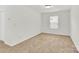 Neutral bedroom with bright natural light from large window and neutral carpeting at 1828 Aston Mill Pl, Charlotte, NC 28273